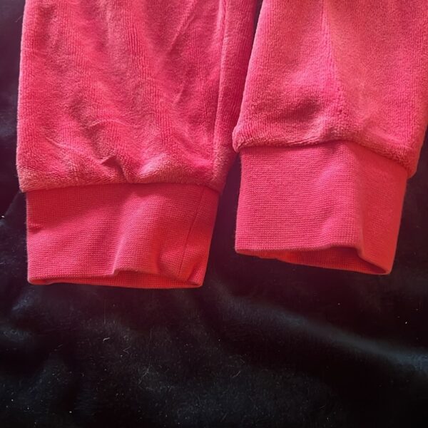 Pair of girl’s pink velour sweatpants by Juicy Couture, size 4/5