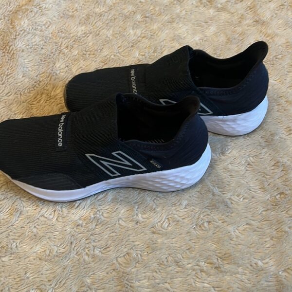 New Balance, like new, pair of black slip on sneakers, size 3